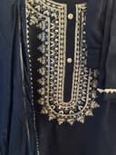 Woman wearing a red embroidered kurti set by Nishtha Chadda