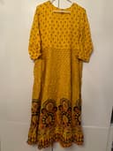 Woman wearing a red embroidered kurti set by Nishtha Chadda