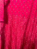 Woman wearing a orange embroidered kurti set by Nishtha Chadda