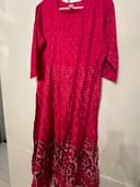 Woman wearing a orange embroidered kurti set by Nishtha Chadda