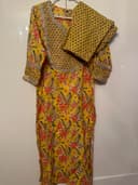 Woman wearing a orange embroidered kurti set by Nishtha Chadda