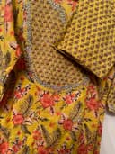 Woman wearing a orange embroidered kurti set by Nishtha Chadda