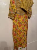Woman wearing a brown embroidered kurti set by Nishtha Chadda