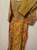 Woman wearing a brown embroidered kurti set by Nishtha Chadda