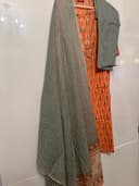 Woman wearing a brown embroidered kurti set by Nishtha Chadda