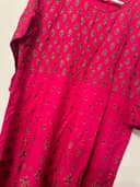 Woman wearing a brown embroidered kurti set by Nishtha Chadda