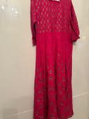 Woman wearing a brown embroidered kurti set by Nishtha Chadda