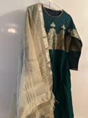 Woman wearing a black embroidered kurti set by Nishtha Chadda