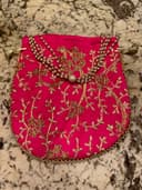 Woman wearing a red embroidered kurti set by Nishtha Chadda