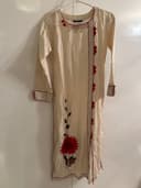 Woman wearing a maroon embroidered kurti set by Nishtha Chadda