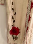 Woman wearing a maroon embroidered kurti set by Nishtha Chadda