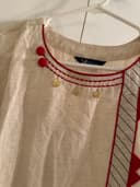 Woman wearing a brown embroidered kurti set by Nishtha Chadda