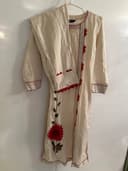 Woman wearing a brown embroidered kurti set by Nishtha Chadda