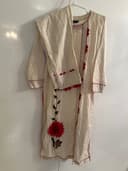 Woman wearing a brown embroidered kurti set by Nishtha Chadda