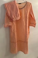 Woman wearing a brown embroidered kurti set by Nishtha Chadda