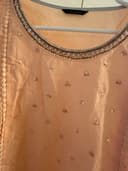 Woman wearing a brown embroidered kurti set by Nishtha Chadda