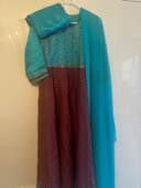 Woman wearing a teal embroidered kurti set by Nishtha Chadda