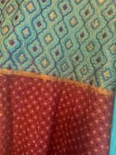 Woman wearing a teal embroidered kurti set by Nishtha Chadda