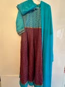 Woman wearing a teal embroidered kurti set by Nishtha Chadda