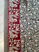 Woman wearing a maroon embroidered kurti set by Nishtha Chadda