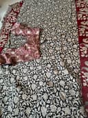 Woman wearing a maroon embroidered kurti set by Nishtha Chadda