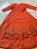 Woman wearing a maroon embroidered kurti set by Nishtha Chadda