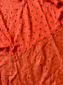 Woman wearing a maroon embroidered kurti set by Nishtha Chadda
