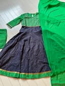 Woman wearing a maroon embroidered kurti set by Nishtha Chadda