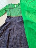 Woman wearing a maroon embroidered kurti set by Nishtha Chadda