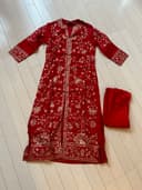 Woman wearing a maroon embroidered kurti set by Nishtha Chadda