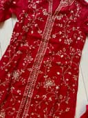 Woman wearing a maroon embroidered kurti set by Nishtha Chadda