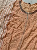 Woman wearing a brown embroidered kurti set by Nishtha Chadda