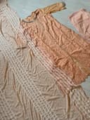 Woman wearing a brown embroidered kurti set by Nishtha Chadda