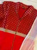 Woman wearing a red embroidered kurti set by Nishtha Chadda