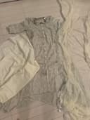 Woman wearing a beige embroidered kurti set by Nishtha Chadda