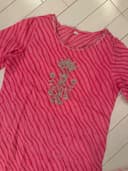 Woman wearing a beige embroidered kurti set by Nishtha Chadda