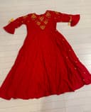Woman wearing a beige embroidered kurti set by Nishtha Chadda