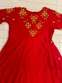 Woman wearing a beige embroidered kurti set by Nishtha Chadda