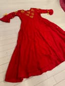 Woman wearing a beige embroidered kurti set by Nishtha Chadda