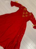 Woman wearing a beige embroidered kurti set by Nishtha Chadda