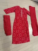 Woman wearing a beige embroidered kurti set by Nishtha Chadda