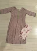 Woman wearing a beige embroidered kurti set by Nishtha Chadda