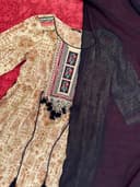Woman wearing a coral embroidered kurti set by Nishtha Chadda