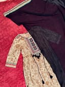 Woman wearing a red embroidered kurti set by Nishtha Chadda