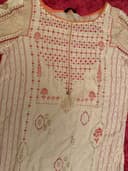 Woman wearing a brown embroidered kurti set by Nishtha Chadda