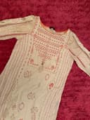 Woman wearing a brown embroidered kurti set by Nishtha Chadda