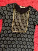 Woman wearing a brown embroidered kurti set by Nishtha Chadda