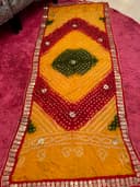 Woman wearing a maroon embroidered kurti set by Nishtha Chadda