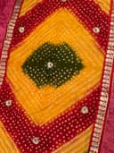 Woman wearing a orange embroidered kurti set by Nishtha Chadda