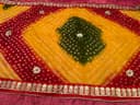 Woman wearing a orange embroidered kurti set by Nishtha Chadda